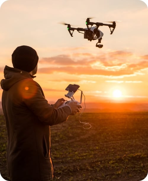 Man operating a drone with remote control.