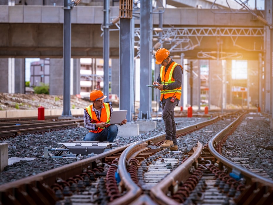 Engineer under inspection and checking construction process railway switch and checking work on railroad station .-min